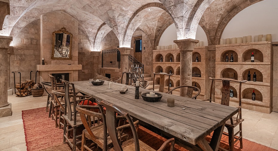 A dining table and chairs within the massive estate