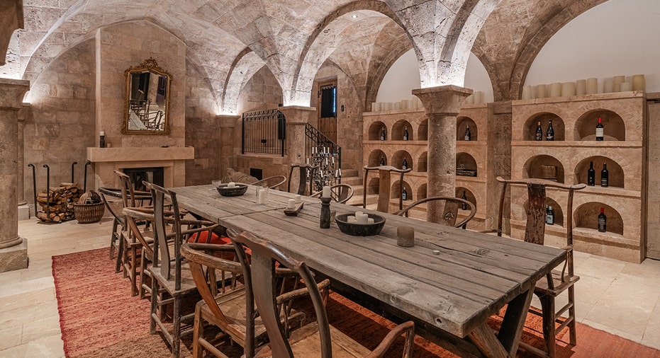 A dining table and chairs within the massive estate