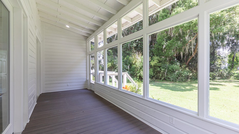 The guest house boasts a sunroom, with floor-to-ceiling windows.