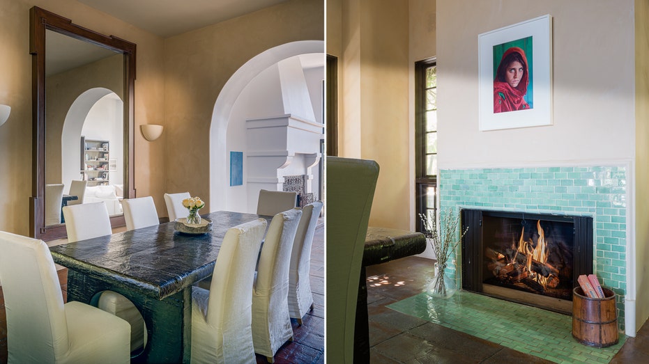 The dining room features a unique blue table and a fireplace surrounded by green tile.