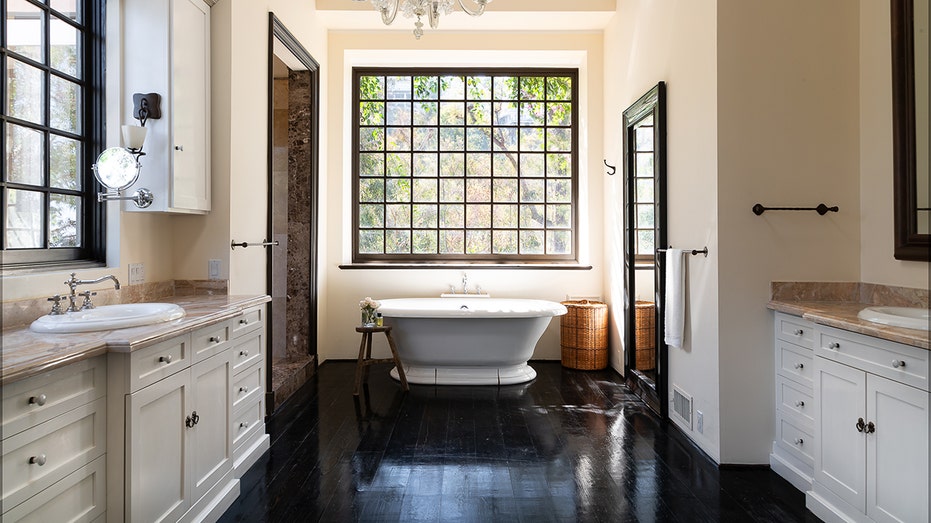 The en-suite bathroom has a soaking tub, stand-up shower and dual vanities.