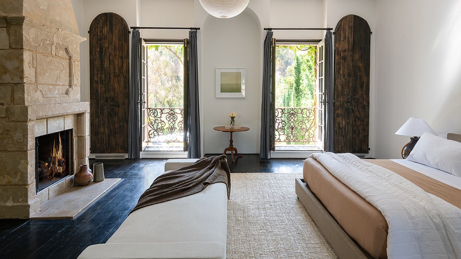 The first bedroom has a stone fireplace and Juliet balconies.