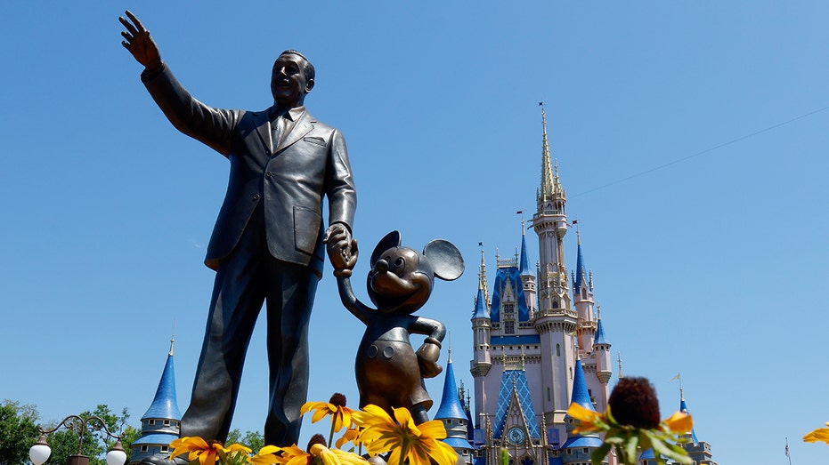 ORLANDO, FL - MAY 31: A statue of Walt Disney and Mickey Mouse stands in a garden in front of Cinderella's Castle at the Magic Kingdom Park at Walt Disney World on May 31, 2024, in Orlando, Florida. (Photo by Gary Hershorn/Getty Images)