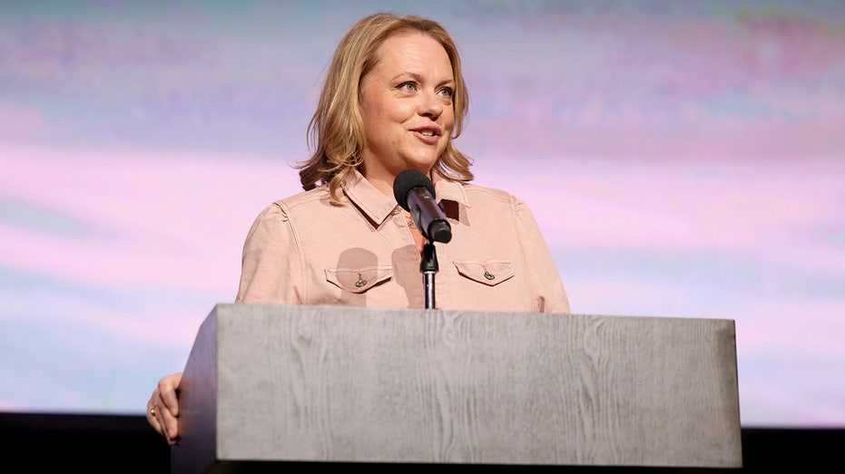 Lisa Hamilton Daly standing at a podium