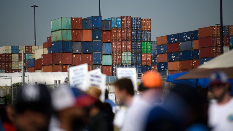 Dock workers demonstrate in front of the closed port