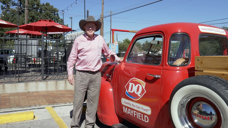 Robert Mayfield stands next to a 1953 Chevy pickup with the Dairy Queen logo