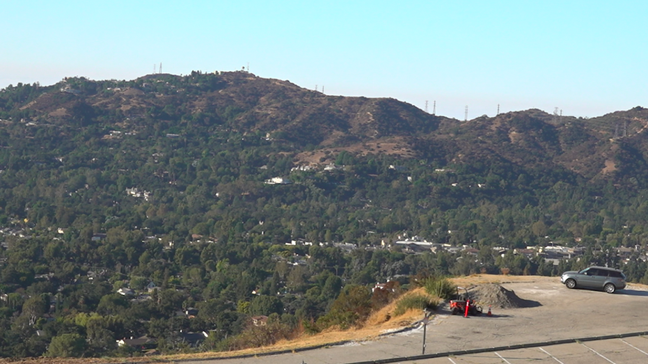 Photo of mountains with a parking lot in the forefront of the picture