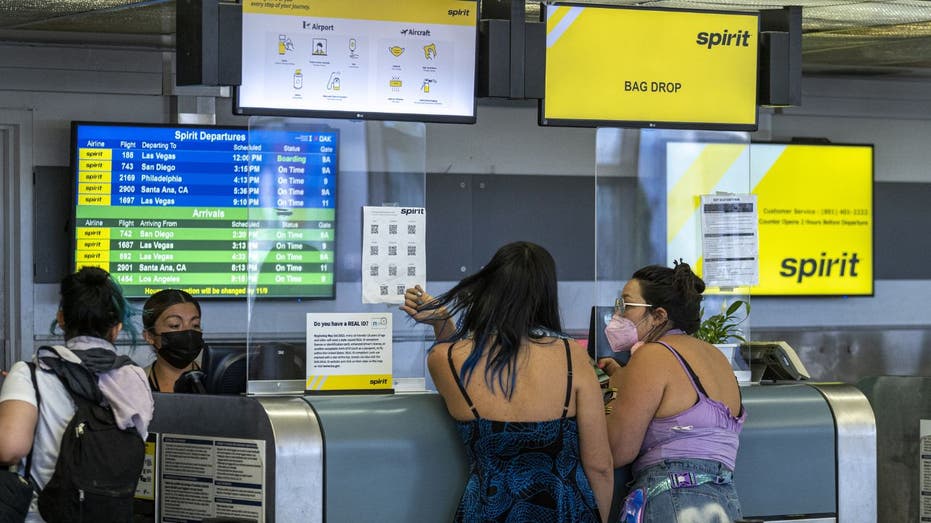 Passengers at Spirit Airlines check-in desk