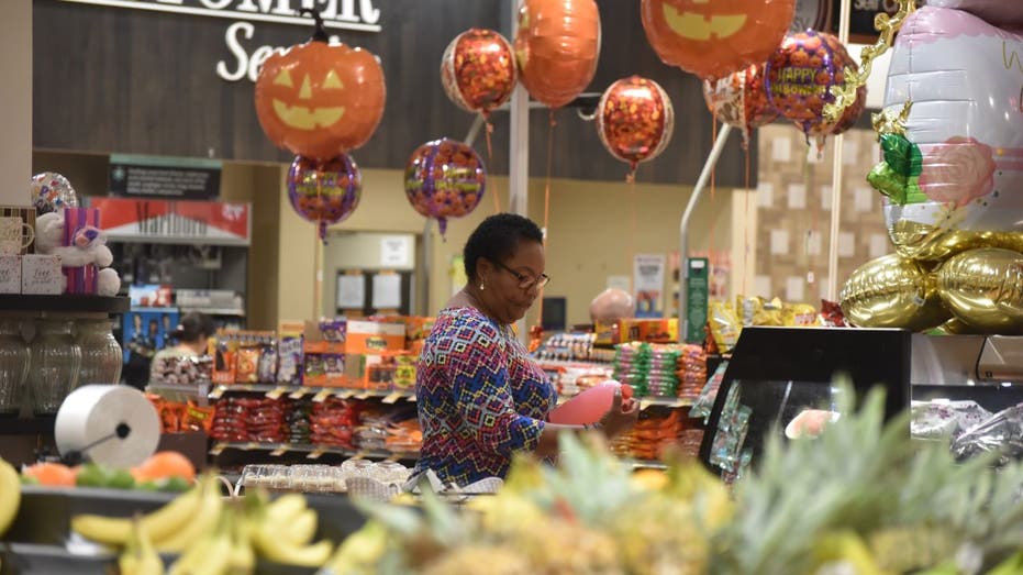 Customer shopping at grocery store with Halloween decorations