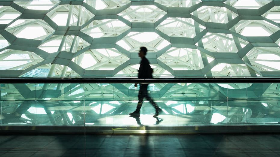 man walking through office building