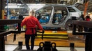 Employees assemble components of a Jeep Cherokee vehicle on the production line at the Chrysler Toledo Assembly Plant in Toledo, Ohio, U.S., on Friday, Feb. 28, 2014. Fiat SpA is considering selling about 1.5 billion euros ($2.05 billion) in mandatory convertible bonds to cut debt following its merger with Chrysler Group LLC, two people familiar with the matter said. Photographer: Ty Wright/Bloomberg via Getty Images