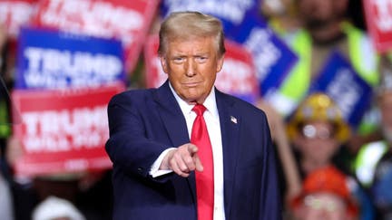 TOPSHOT - Former US President and Republican presidential candidate Donald Trump gestures during a campaign rally at PPG Paints Arena in Pittsburgh, Pennsylvania on November 4, 2024. 