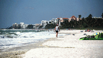 Naples Municipal beach looking north with luxury hotels and condominiums in the background.