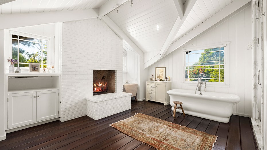 The ensuite bathroom boasts a fireplace, a soaking tub and a standing shower.