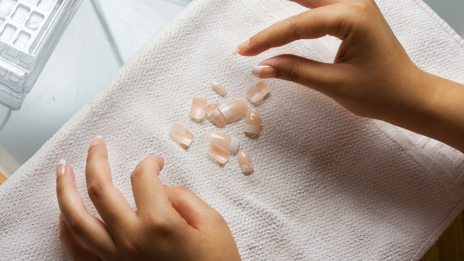 Woman applying press-on nails