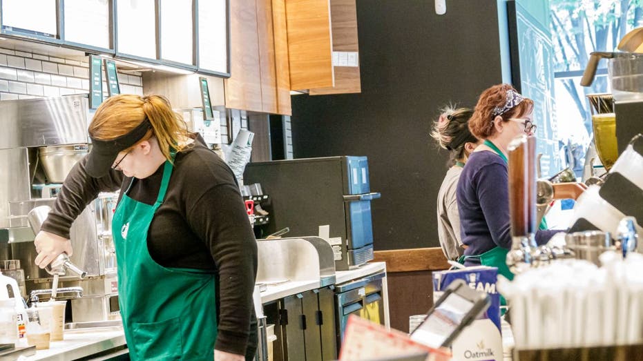 Starbucks Barista serves customers