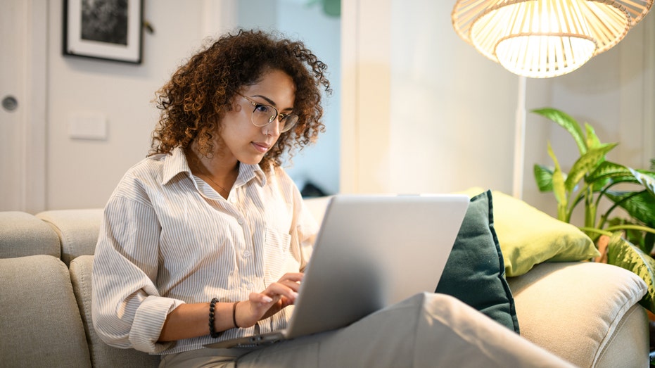 A woman working on her laptop at home