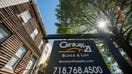 A Century 21 Real Estate LLC &quot;For Sale&quot; sign hangs in front of a property in the Park Slope neighborhood of the Brooklyn borough of New York, U.S., on Tuesday, Sept. 17, 2013. The National Association of Realtors is scheduled to release existing home sales figures on Sept. 19. Photographer: Craig Warga/Bloomberg via Getty Images