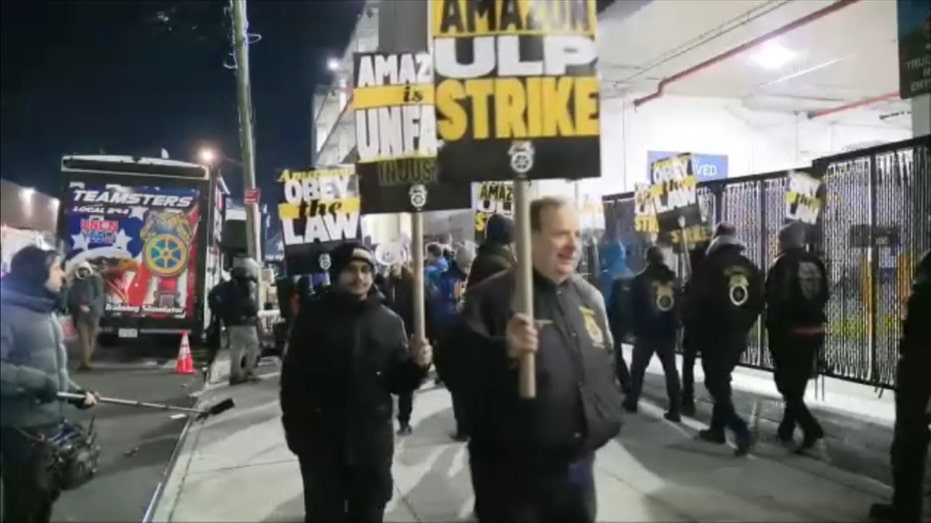 Amazon workers holding protest signs outside