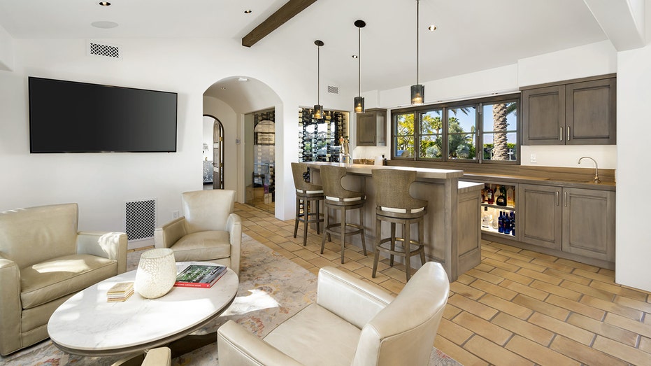 The home also features a bar room, with additional seating, a wind display and a stocked bar.