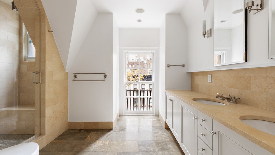 The en suite bathroom features a Juliette balcony, double vanity and shower.