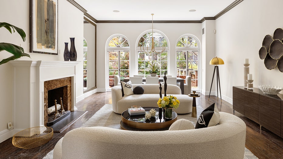 The home's lounge level features a formal living area with arched windows and a fireplace.