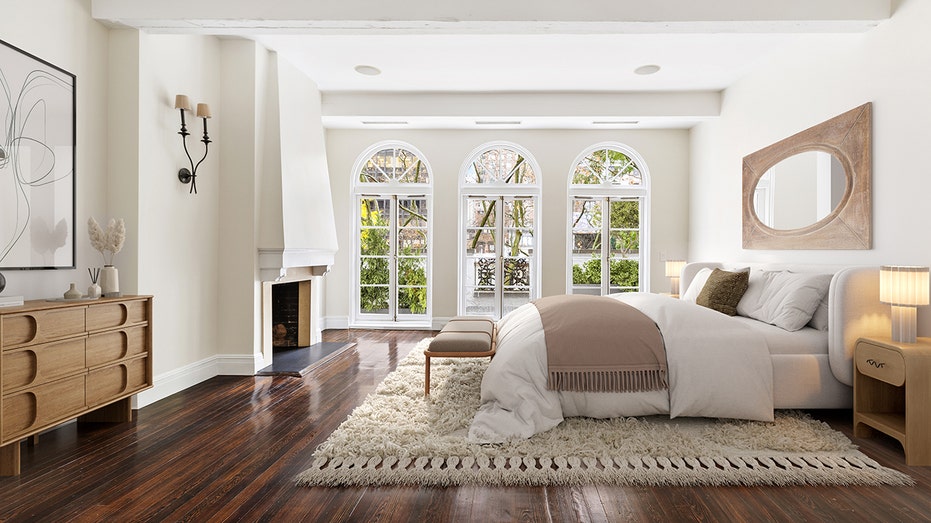 The bedroom has a fireplace and three windows.