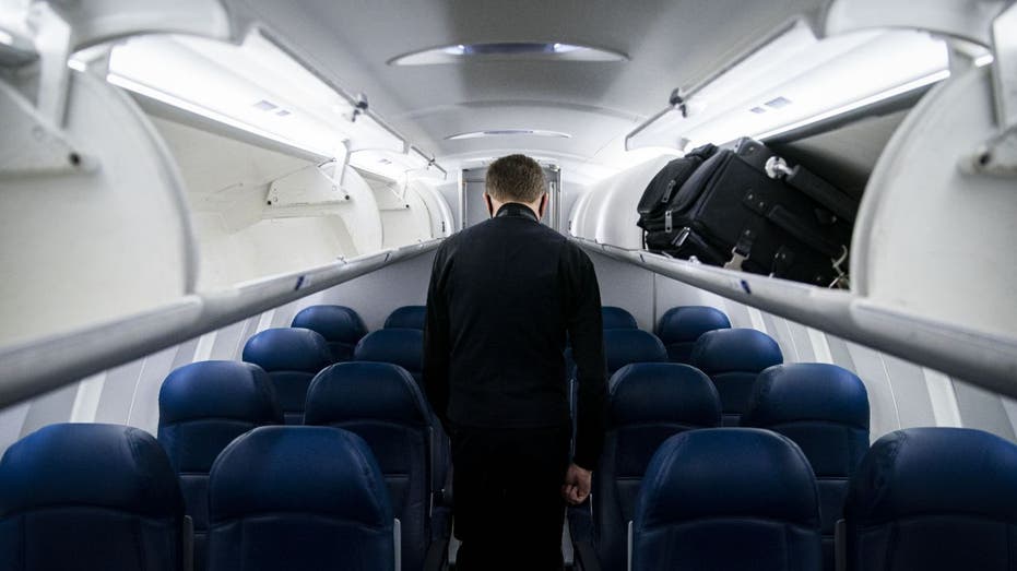 a Delta flight attendant inspects an empty plane