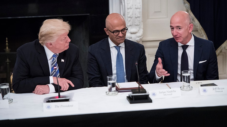 Amazon CEO Jeff Bezos speaks with Trump and Microsoft CEO Satya Nadella