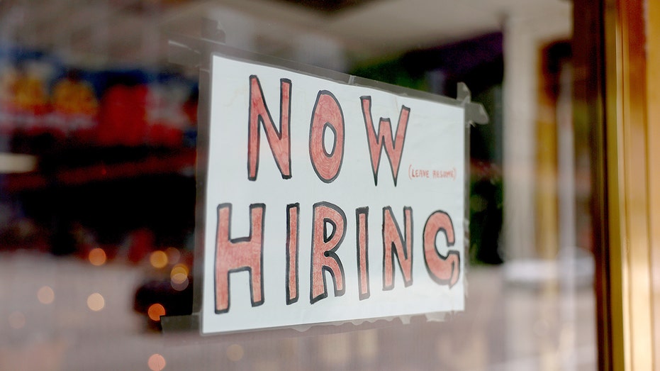 'NOW HIRING' sign