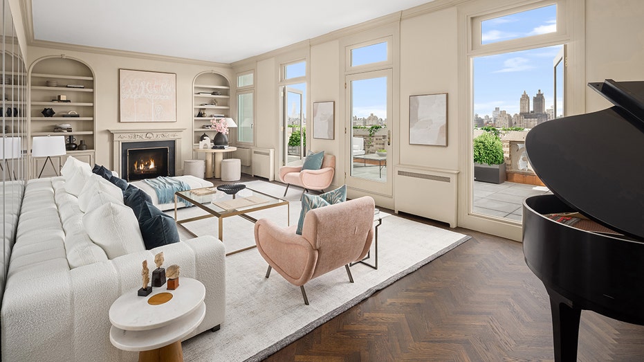 The living room has built-in cupboards and a wood-burning fireplace. 