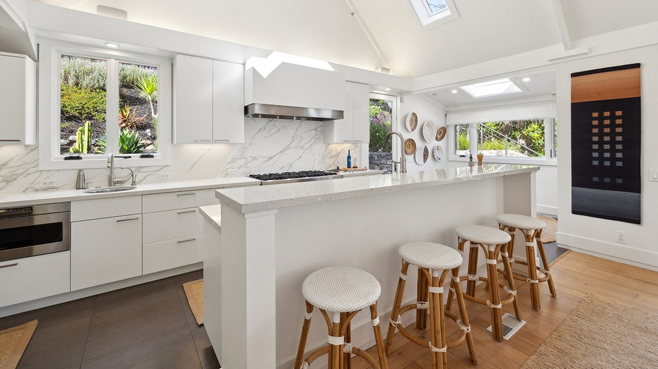 View of Robert Redford's all white kitchen with stools stools