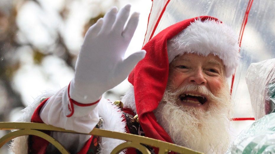 Santa Claus waving to crowd at parade