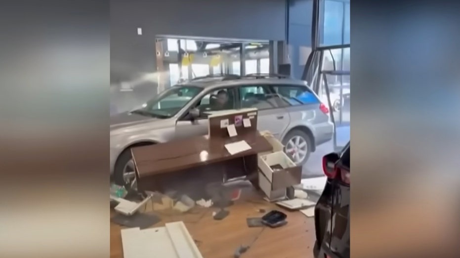 A still taken from video of the incident at the car dealership (Credit: Jam Press)