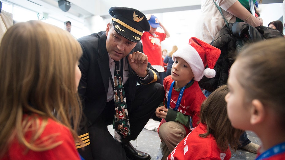 The pilot talking to the children of the mysterious plane