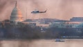 A helicopter flies near the crash site of the American Airlines plane on the Potomac River after the plane crashed on approach to Reagan National Airport. - Fox News