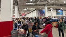 Customers lined up at checkout counters in a very busy Costco store in Queens, New York on an unspecified date. The Oster countertop ovens recalled were sold at Costco and other major retailers.  - Fox Business News