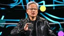 Nvidia CEO Jensen Huang holds a Nvidia&apos;s Drive Thor processor as he delivers a keynote address at the Consumer Electronics Show (CES) in Las Vegas, Nevada on January 6, 2025. Gadgets, robots and vehicles imbued with artificial intelligence will once again vie for attention at the Consumer Electronics Show, as vendors behind the scenes will seek ways to deal with tariffs threatened by US President-elect Donald Trump. The annual Consumer Electronics Show (CES) opens formally in Las Vegas on January 7, 2025, but preceding days are packed with product announcements. 