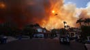 TOPSHOT - Plumes of smoke are seen as a brush fire burns in Pacific Palisades, California on January 7, 2025. A fast-moving brushfire in a Los Angeles suburb burned buildings and sparked evacuations Tuesday as &quot;life threatening&quot; winds whipped the region. More than 200 acres (80 hectares) was burning in Pacific Palisades, a upscale spot with multi-million dollar homes in the Santa Monica Mountains, shuttering a key highway and blanketing the area with thick smoke. 