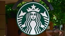  A sign embellished with the Starbucks logo hangs near the entrance to the Starbucks coffee shop in Aspen, Colorado. 