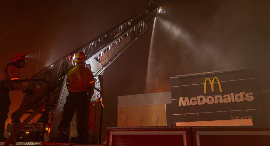 PASADENA, CALIFORNIA - JANUARY 7: Firefighters battle the Eaton Fire as a McDonald's fast food restaurant burns on January 7, 2025 in Pasadena, California. A powerful Santa Ana wind event has dramatically raised the danger of wind-driven wildfires such as the dangerous and destructive Palisades Fire near Santa Monica. The strong winds also forced President Joe Biden to cancel his plan to travel between Los Angeles and Riverside, California. (Photo by David McNew/Getty Images)