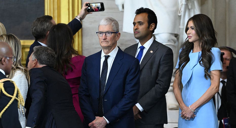 (L-R) Apple CEO Tim Cook, Vivek Ramaswamy and Secretary of Homeland Security nominee Kristi Noem attend the inauguration ceremony before Donald Trump is sworn in as the 47th US President in the US Capitol Rotunda in Washington, DC, on January 20, 2025. (Photo by SAUL LOEB / POOL / AFP) (Photo by SAUL LOEB/POOL/AFP via Getty Images)
