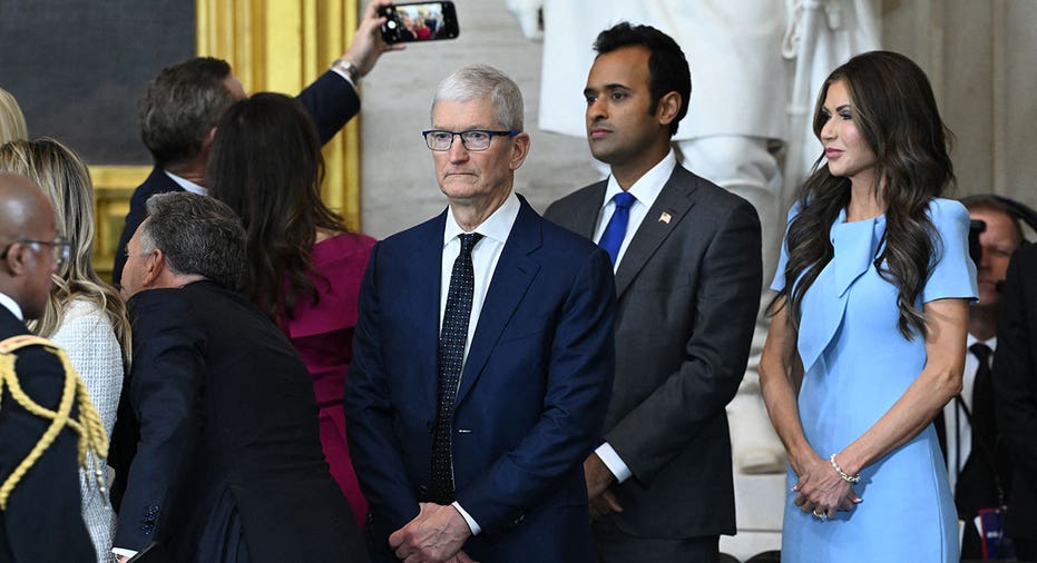 (L-R) Apple CEO Tim Cook, Vivek Ramaswamy and Secretary of Homeland Security nominee Kristi Noem attend the inauguration ceremony before Donald Trump is sworn in as the 47th US President in the US Capitol Rotunda in Washington, DC, on January 20, 2025. (Photo by SAUL LOEB / POOL / AFP) (Photo by SAUL LOEB/POOL/AFP via Getty Images)