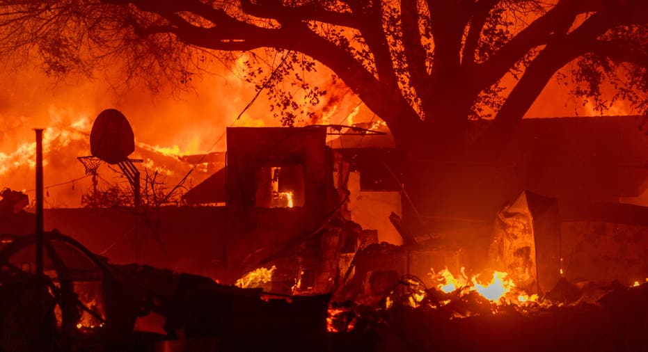 PASADENA, CALIFORNIA - JANUARY 7: Homes burn as powerful winds drive the Eaton Fire on January 7, 2025 in Pasadena, California. A powerful Santa Ana wind event has dramatically raised the danger of wind-driven wildfires such as the dangerous and destructive Palisades Fire near Santa Monica. The strong winds also forced President Joe Biden to cancel his plan to travel between Los Angeles and Riverside, California. (Photo by David McNew/Getty Images)