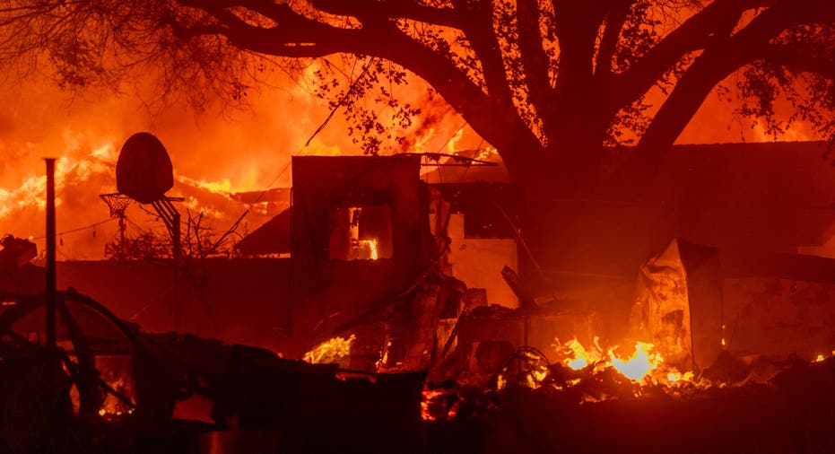 PASADENA, CALIFORNIA - JANUARY 7: Homes burn as powerful winds drive the Eaton Fire on January 7, 2025 in Pasadena, California. A powerful Santa Ana wind event has dramatically raised the danger of wind-driven wildfires such as the dangerous and destructive Palisades Fire near Santa Monica. The strong winds also forced President Joe Biden to cancel his plan to travel between Los Angeles and Riverside, California. (Photo by David McNew/Getty Images)