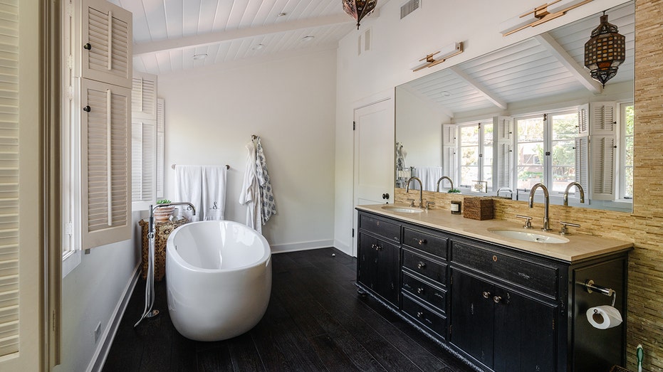 The ensuite bathroom boasts a soaking tub and a large vanity.