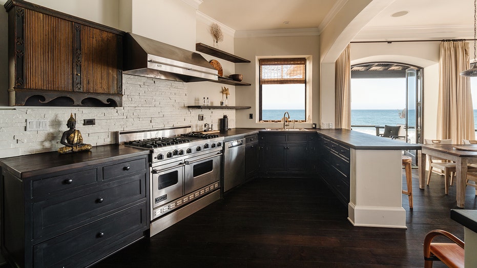 The kitchen boasts dark countertops and a double oven.