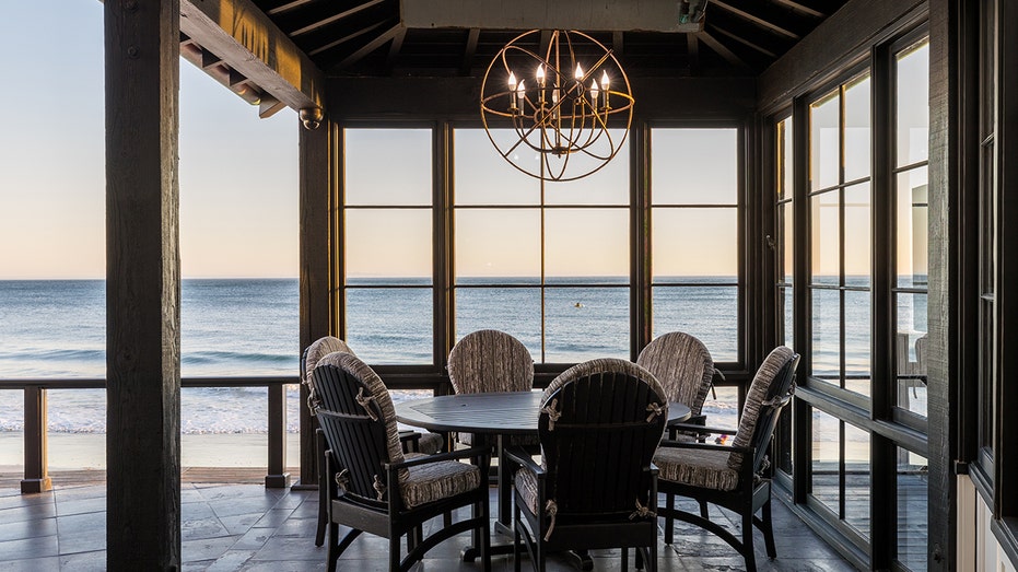 The back deck features an outdoor dining area overlooking the beach.