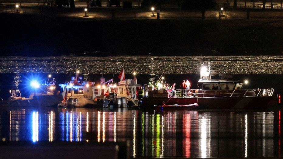 Emergency personnel and divers work at the site of the crash after American Eagle flight 5342 collided with a Black Hawk helicopter while approaching Reagan Washington National Airport and crashed into the Potomac River, outside Washington, D.C., on Jan. 30, 2025.