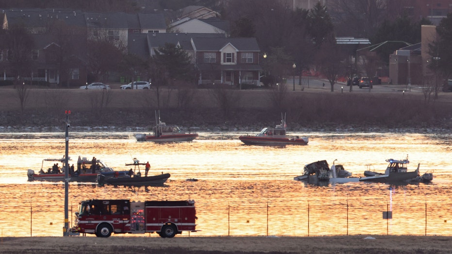 Emergency personnel work at the site of the crash after a Black Hawk helicopter and an American Eagle flight 5342 approaching Reagan Washington National Airport collided and crashed in the Potomac River, outside Washington, Jan. 30, 2025.